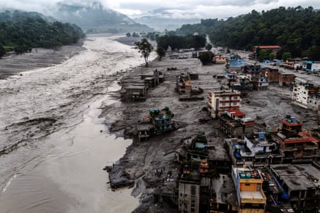 Damaged buildings and houses covered in mud next to the Likhu River following deadly flash floods and mudslides, in Devighat, Nuwakot district, Nepal.