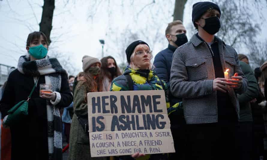A woman holds a placard remembering Asling Murphy, who was murdered while out for a run