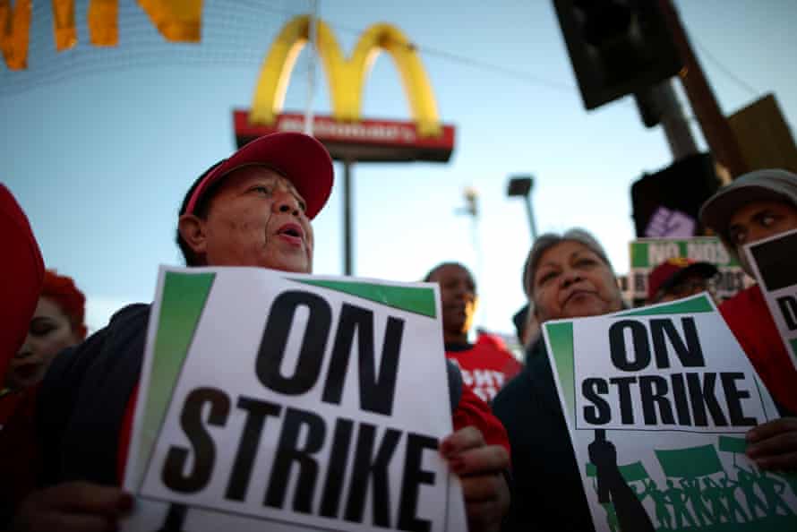 People participate in a ‘Fight for $15’ wage protest in Los Angeles, California.