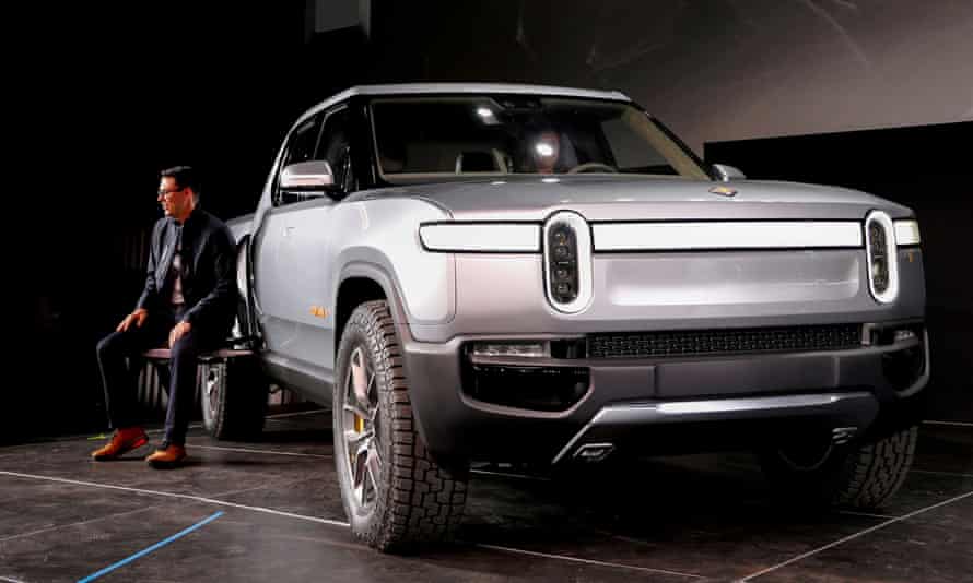 RJ Scaringe sits next to truck