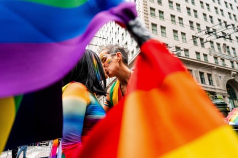 Jennifer Kanenaga, left, and AnMarie Rodgers kiss before kicking off San Francisco’s Pride parade as part of the Dykes on Bikes contingent on 25 June 2023.