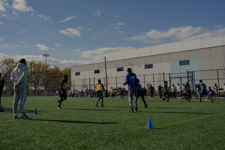 Monitoring Amazon: the New Yorkers monitoring air pollution from supply hubs | Amazon 7 An Amazon warehouse is seen behind Red Hook ball fields during a youth football practice.