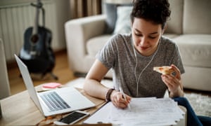 Female student studying and listening to music at home