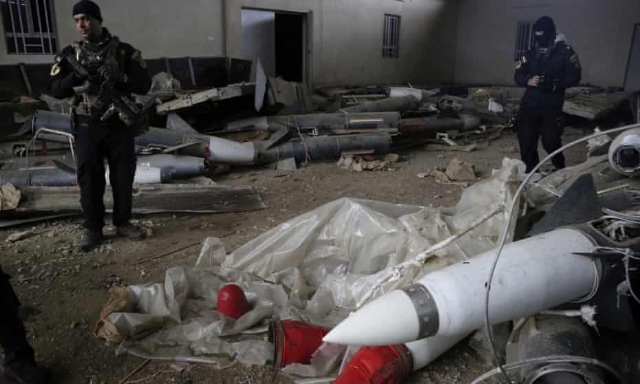 Iraqi special forces troops inspect missiles found in a warehouse in eastern Mosul, Iraq, on Saturday.