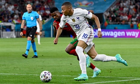 Kylian Mbappe (right) of France is challenged by Nelson Semedo of Portugal for the ball.