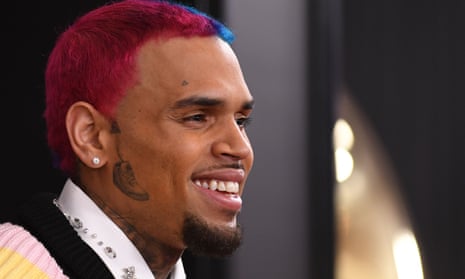 man with red and blue hair smiles