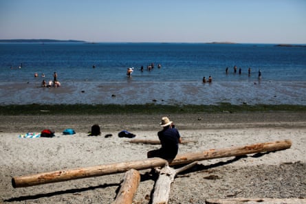 People cool off at Willow’s Beach in Victoria, British Columbia. The heatwave has extended across the US north-west and south-western Canada.