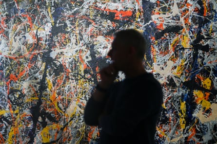 National Gallery of Australia senior paintings conservator David Wise inspects the paintwork of Blue Poles.