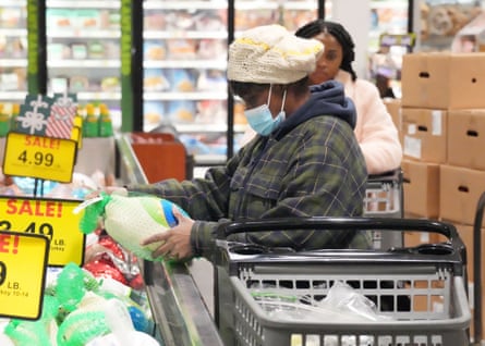 A customer inspects a frozen turkey in a Missouri grocery store in November last year. Turkeys cost 73% more last year due to inflation and avian flu.