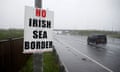 A poster protesting against the Irish sea border next to a road