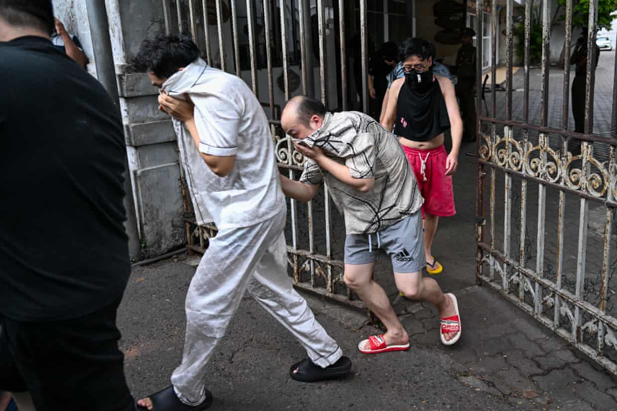 Detained Chinese nationals suspected of running scam centres are escorted to a prison after their arrest in Colombo.