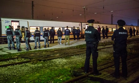 Bosnian police at Bihac train station await a train full of migrants arriving from Sarajevo