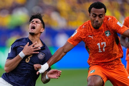 Ecuador’s Piero Hincapie goes down in dramatic fashion as he battles for the ball with Côte d’Ivoire’s Guéla Doué