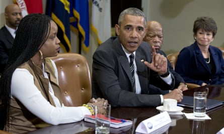 Brittany Packnett of Black Lives Matter listens as Barak Obama addresses the media during the meeting at the White House.