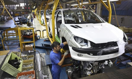 An Iranian worker assembles a Peugeot 206 at the state-run Iran Khodro plant near Tehran