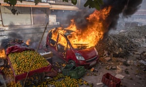 The cars of protesters opposing a new citizenship law are set ablaze in Delhi, India.