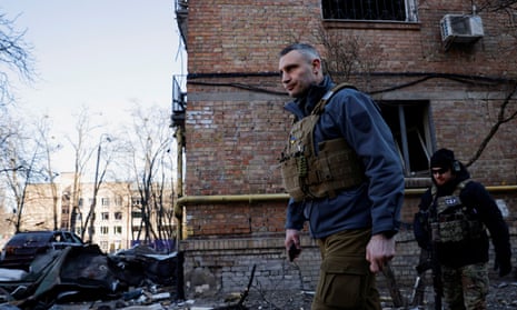 Kyiv Mayor Vitali Klitschko inspects a neighbourhood where a shell hit a residential building, in Kyiv in March