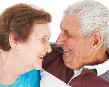 Portrait photo of an older couple looking at each other and smiling