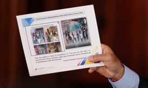 Venezuela’s President Nicolas Maduro holds a placard that reads ‘Fake pictures presented by Iván Duque at the UN’ during a news conference in Caracas, Venezuela, on Monday.