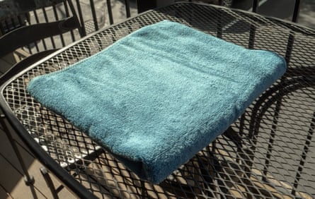 The Amazon Basic Bath Towel on a table outside