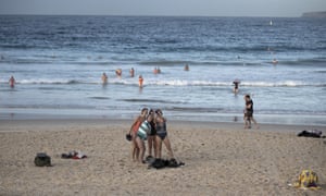 Swimmers take a selfie at Bondi Beach in Sydney on 15 May. Australia’s coronavirus lockdown rules and restrictions are gradually being lifted, but when will they end? Get the latest Covid-19 guidelines explained, and your questions answered, like ‘How many people can I have in my house?’ and ‘Can I travel from NSW to Victoria?’