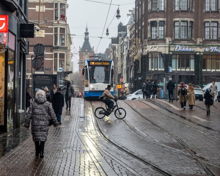 People walking near a GVB tram in Amsterdam, the Netherlands