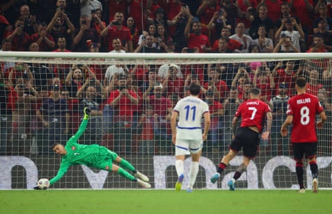 Djordje Petrovic dives to his right to save Rey Manaj’s penalty