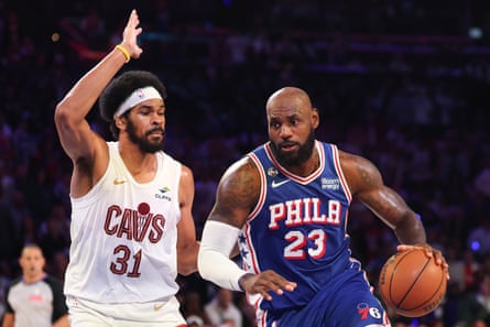 LeBron James carrying the ball past Jarrett Allen of the Cleveland Cavaliers.