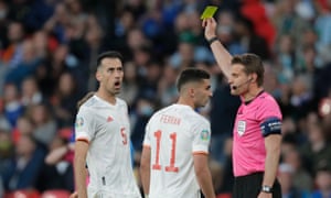 Referee Dr. Felix Brych delivers Sergio Busquets from Spain.