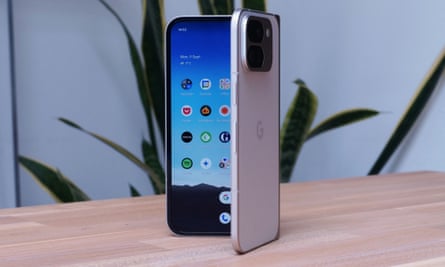 A metallic Google Pixel 9 Pro Fold phone stood upright on a wooden table