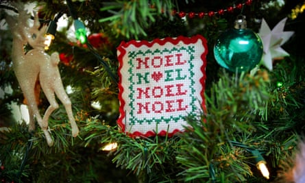 Hand stitched Christmas ornament with the word Noel embroidered on it.