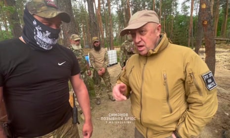 Wagner leader Yevgeny Prigozhin (R) visits a Wagner camp at an undisclosed location.