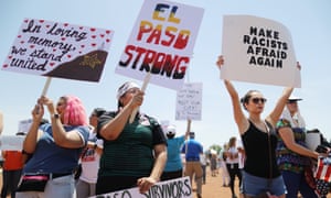Demonstrators stand at a protest against Trump’s visit in El Paso, Texas Wednesday.