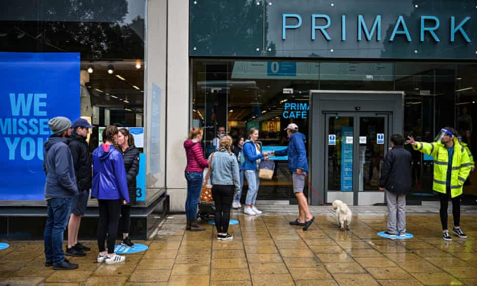 Shoppers queue while observing physical distancing guidelines outside Primark on Princess Street, Edinburgh.