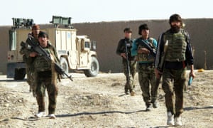 Afghan National Army soldiers patrol in Helmand on Monday. Much of the town of Sangin has been taken over by Taliban forces.