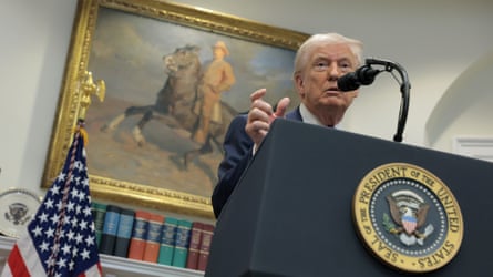 Donald Trump stood at a lectern in front of an image of a man riding a horse