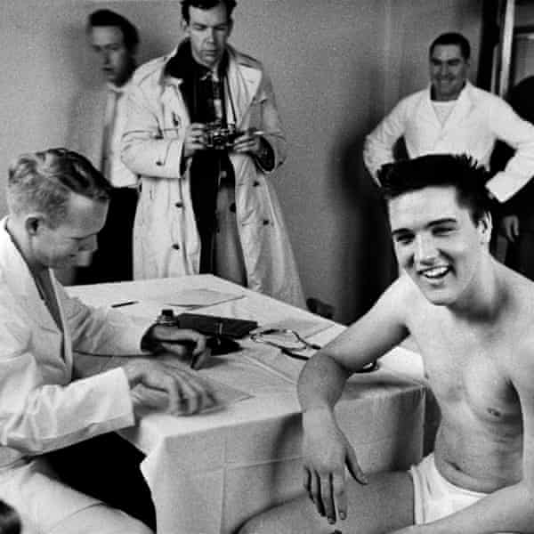 Elvis Presley is examined by an army doctor during his pre-induction physical in 1958.