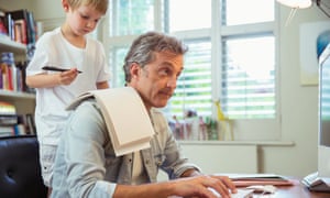 young boy distracting man in office