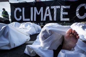 A ‘remember climate deaths’ event at the Cop gates, featuring 20 shrouded ‘bodies’