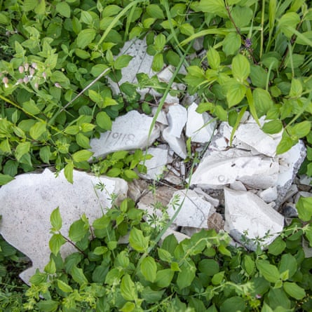 Smashed memorial stones in the grass