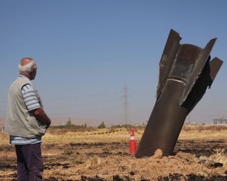 A Syrian farmer looks at an Iranian missile that fell into agricultural land.