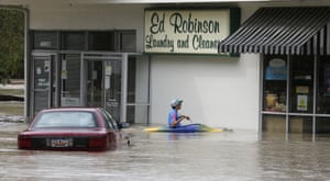 Jordan Bennett paddles to a flooded shop in Columbia