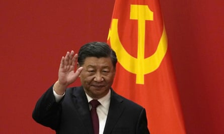 Xi Jinping waving with flag behind him