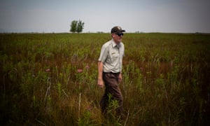 David Lucas, US Fish and Wildlife manager of the Rocky Flats National Wildlife Refuge, walks through a field on the property.