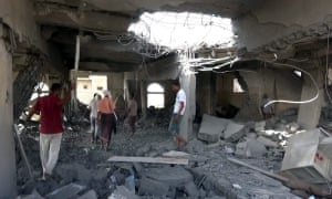 People inspect a prison allegedly targeted by Saudi-led coalition warplanes in Hodeidah, Yemen