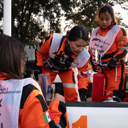 Members of an all-female intervention fire rescue truck team prepare their vehicle and equipment in advance of the races at the Mexico Grand Prix.