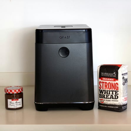 A black Graef bread maker sits between a jar of chocolate spread and a bag of flour