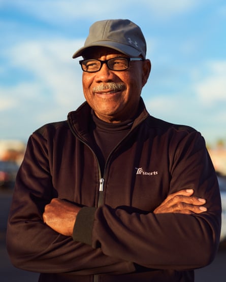 Man with gray mustache and black quarter-zip jacket