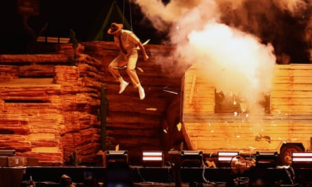 man jumping in the air on a smoky stage