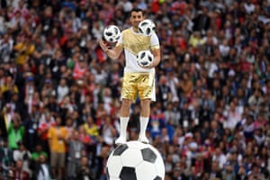 A performer juggles with three footballs during the opening Ceremony